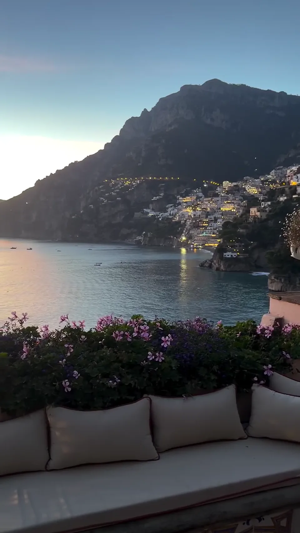 A coastal terrace overlooking the sea in evening light.